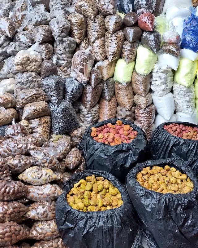 Diverse seeds, nuts and plant products displayed at a local market